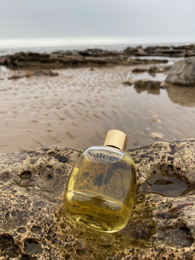 Jamaica by Nateeva, a round bottle shown against a beach backdrop
